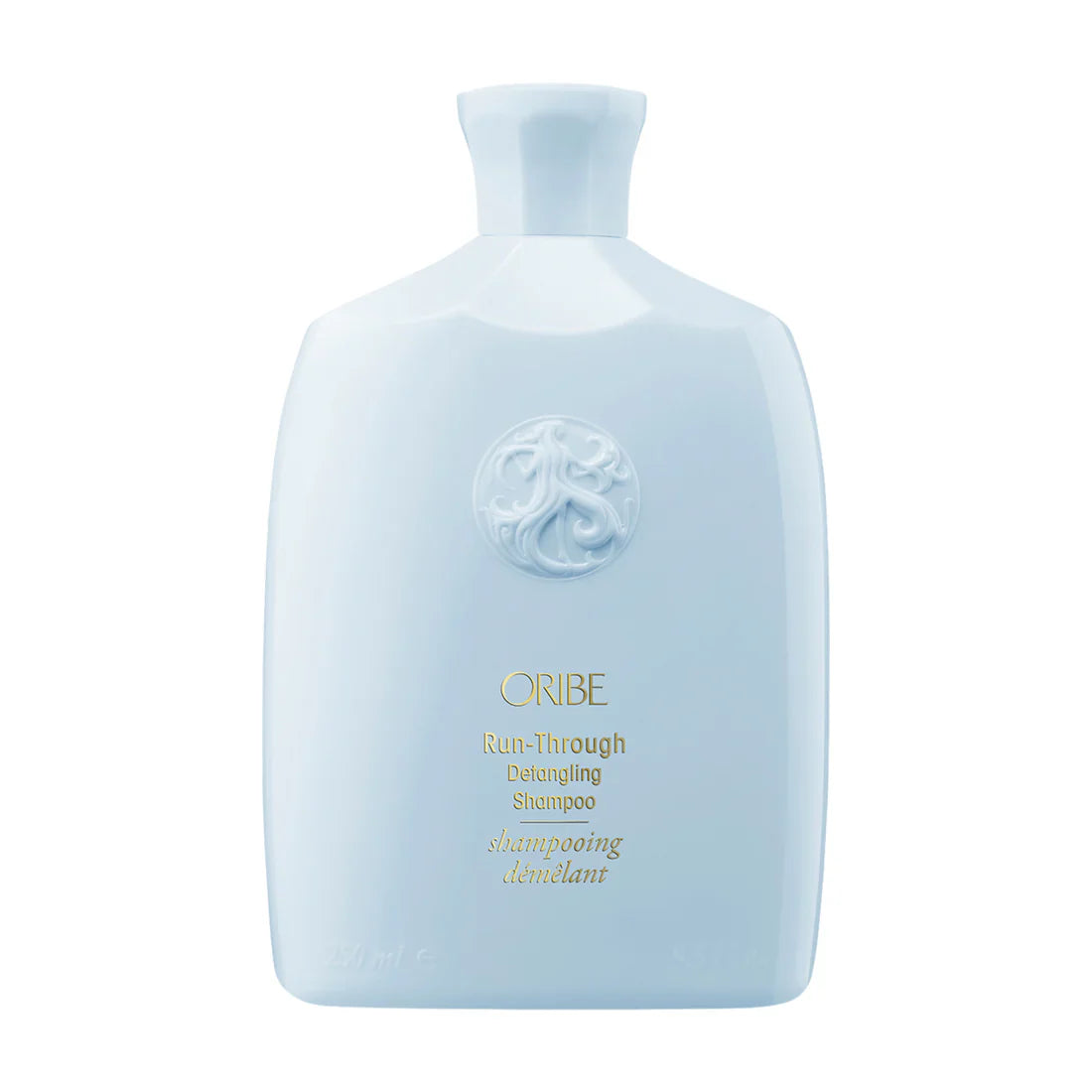 Light blue bottle of Oribe Run-Through Detangling Shampoo 8.5 oz