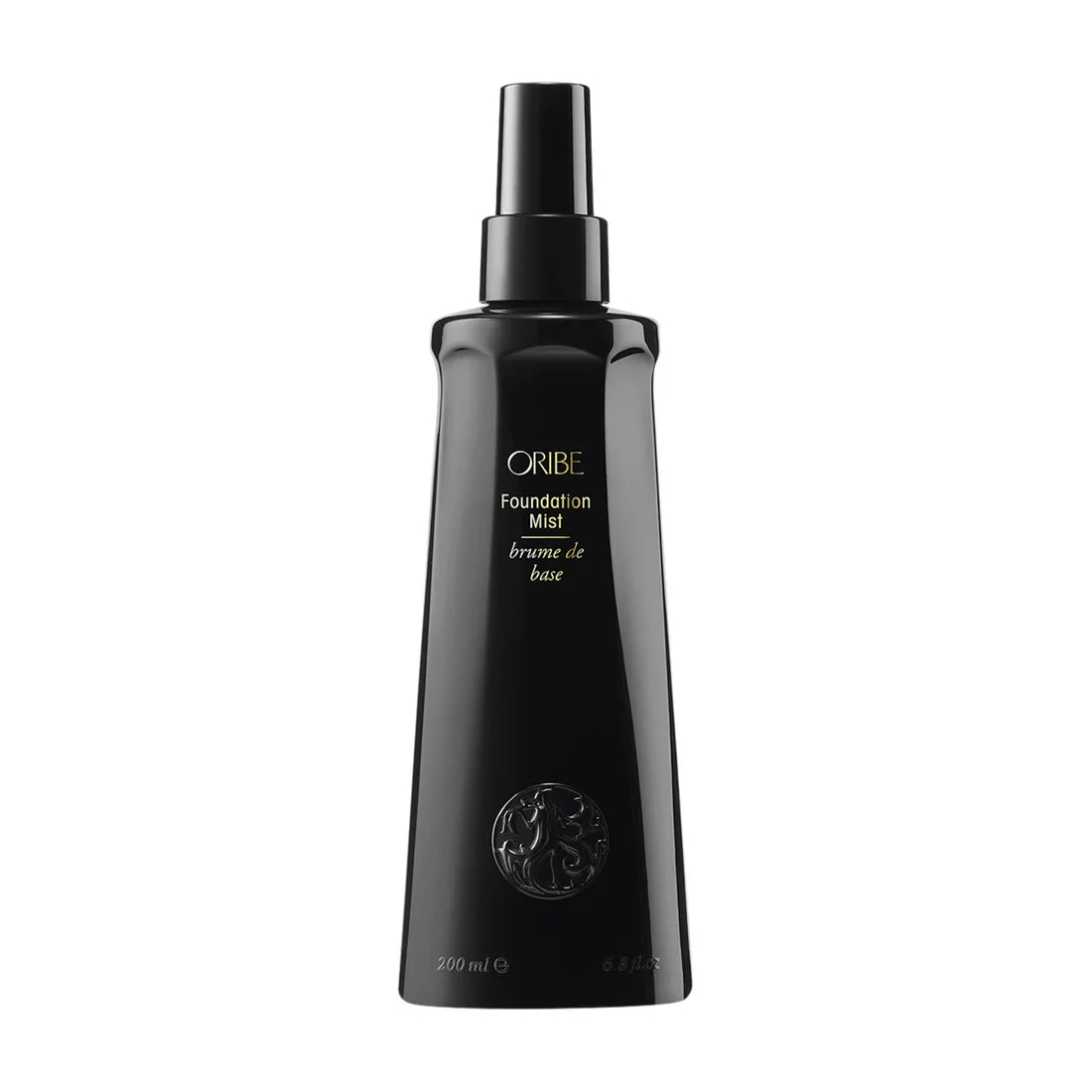 Glossy black bottle of Oribe Foundation Mist with gold text branding