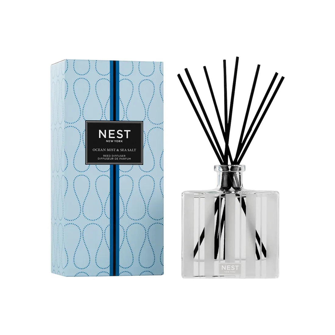 Minimalist glass Ocean Mist and Sea Salt reed diffuser in a coastal-inspired room setting