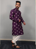 Man wearing a violet silk kurta with geometric metallic copper sequence embroidery and a button-up collar.