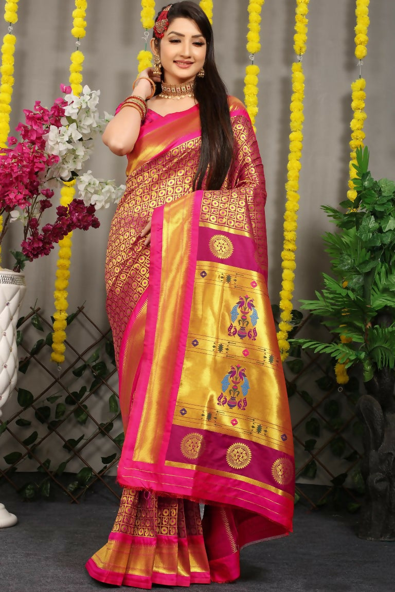 Rich magenta Banarasi silk saree with gold Zari woven patterns and a coordinating pink blouse.
