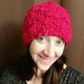 A vibrant handmade beanie made from sustainable banana fiber yarn, displayed as a knitting kit project.