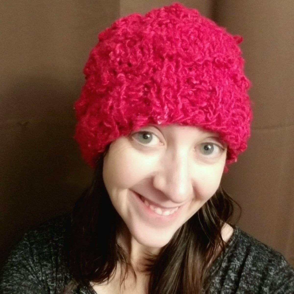 A vibrant handmade beanie made from sustainable banana fiber yarn, displayed as a knitting kit project.
