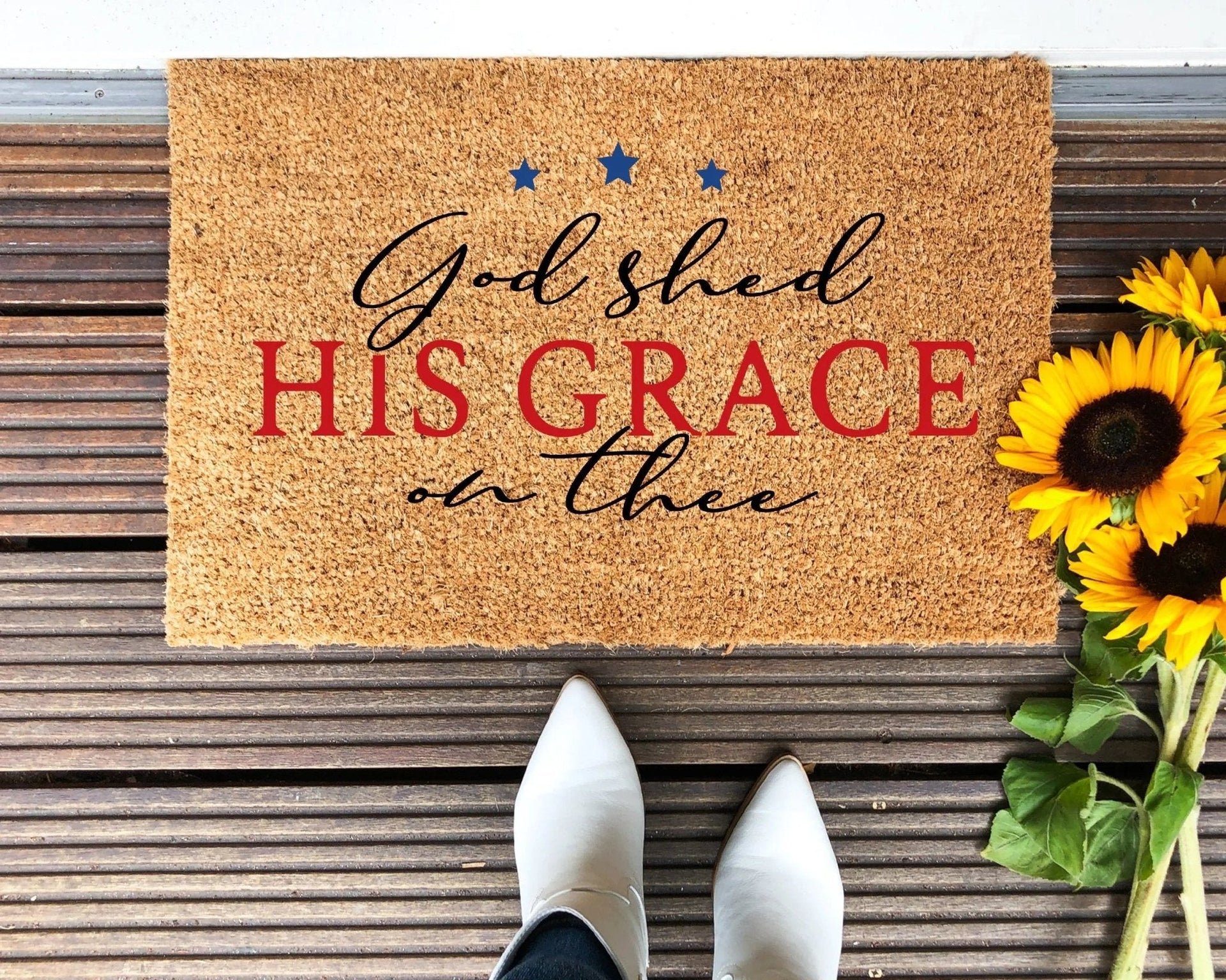 Patriotic God Shed His Grace On Thee doormat with natural coir texture on a porch