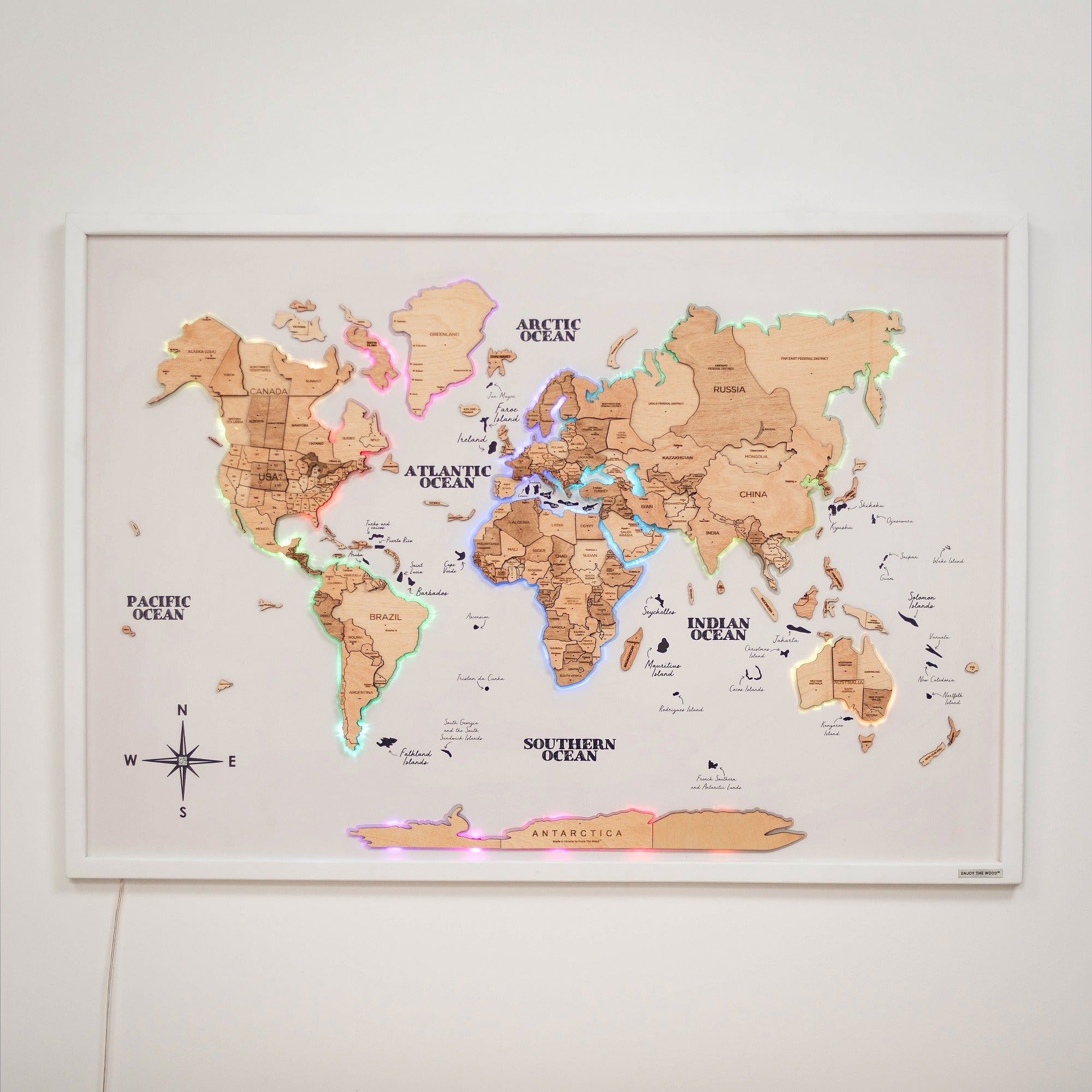Handcrafted gold wooden world map on board with integrated LED lighting