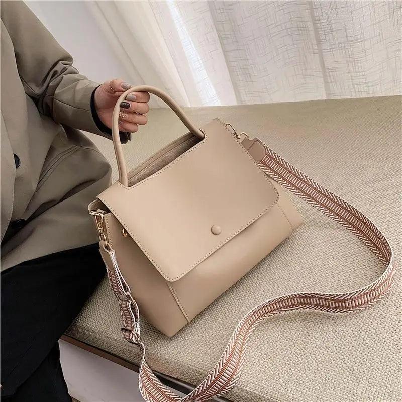 Elegant large capacity PU leather shoulder bag with adjustable strap and buckle closure