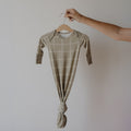 Newborn wearing a minimalist Linen Grid print bamboo knotted gown in a relaxed shift silhouette