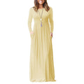 A woman wearing a solid color long-sleeve maxi dress with an elastic waist and side pockets.