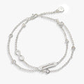 Double strand chain bracelet featuring an infinity symbol charm in gold and silver.