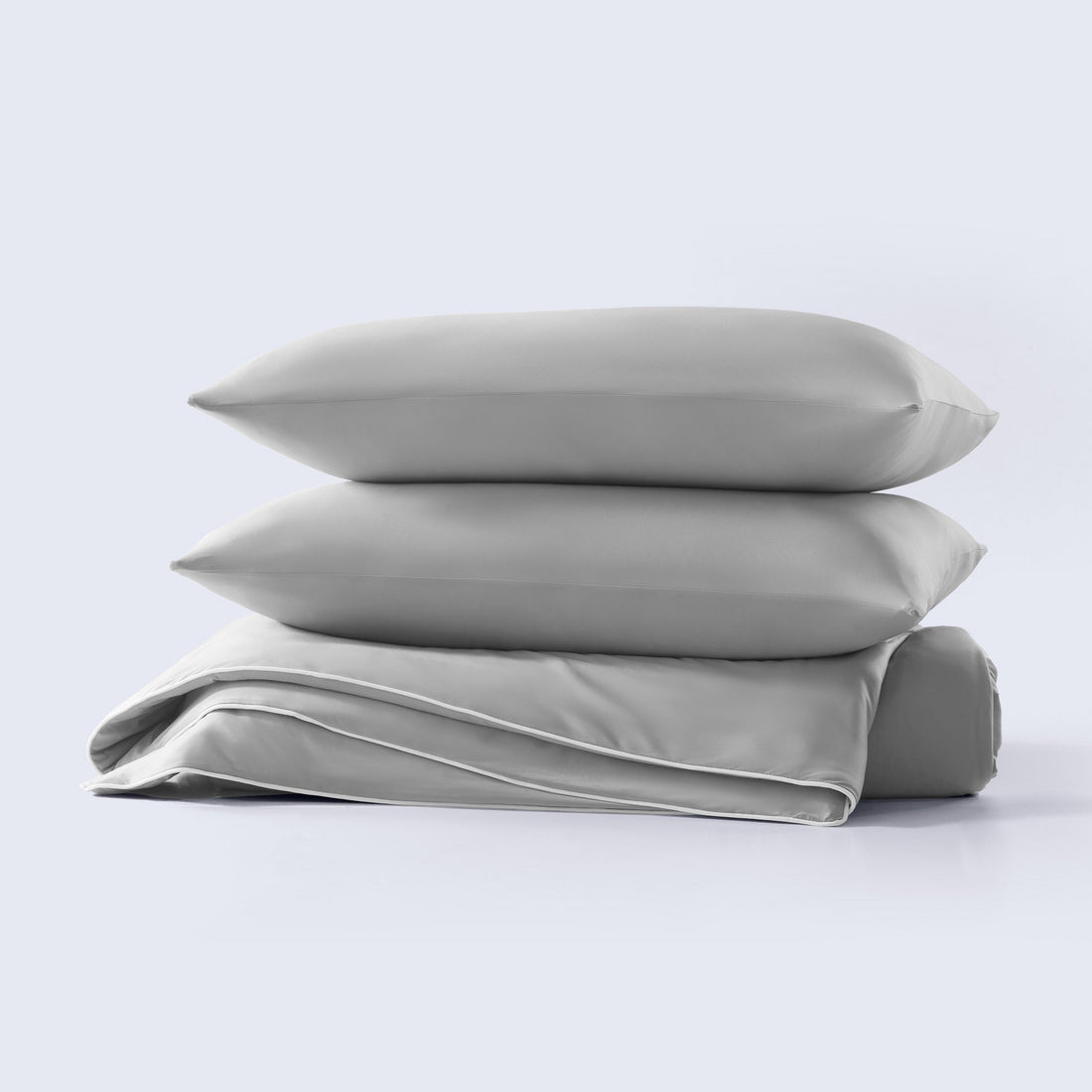 A grey cooling comforter set with matching pillow shams shown on a made bed.