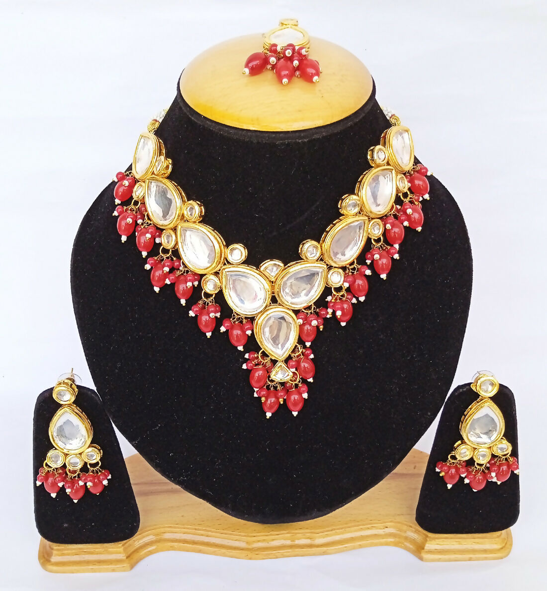 Close up of red Kundan necklace set with gold plated finish