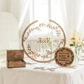 Round acrylic wedding guest book sign displayed on a reception table