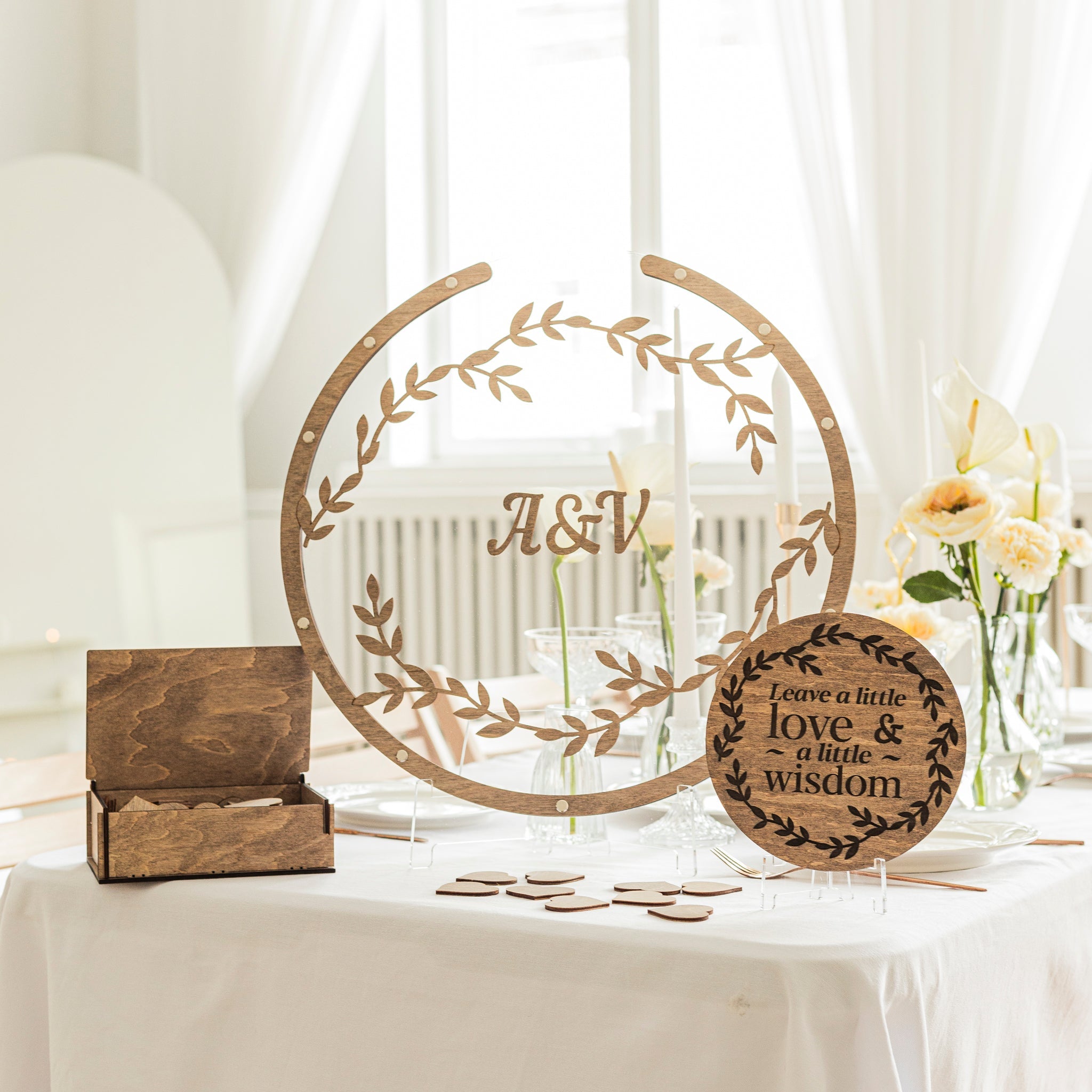 Round acrylic wedding guest book sign displayed on a reception table