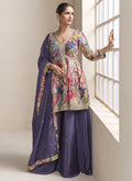 Woman wearing a glamorous violet chinon palazzo suit with vibrant multi-colored floral embroidery