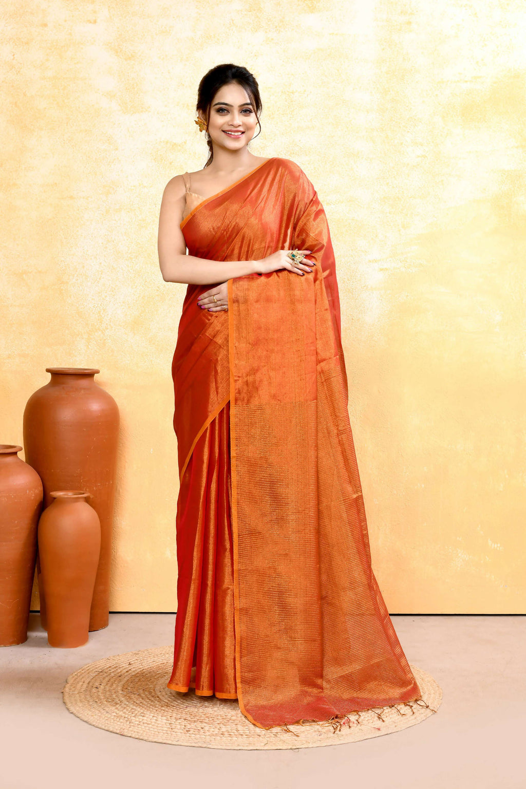 Rust dual tone organic tissue saree with a subtle shimmer finish.