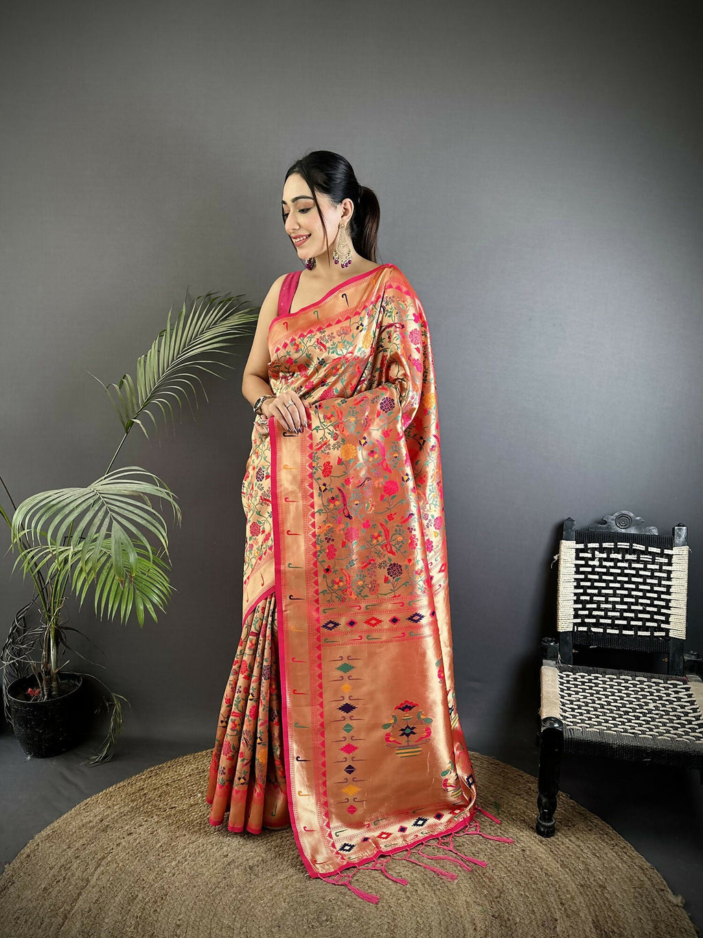 Rani Pink soft silk Paithani saree featuring intricate floral and leaf patterns with matching blouse fabric.