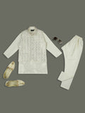 A boys cream-colored kurta and pyjama set paired with a sequence-work Nehru jacket.