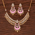 Elegant Golden White Pink Kundan necklace set with pearl and onyx stone detailing displayed on a professional background.