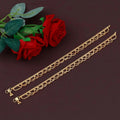 A pair of traditional golden copper anklets with a polished finish and hook closure
