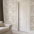 Close up of Halen wallpaper featuring sage-green and blush pink floral chinoiserie pattern on an off-white background.