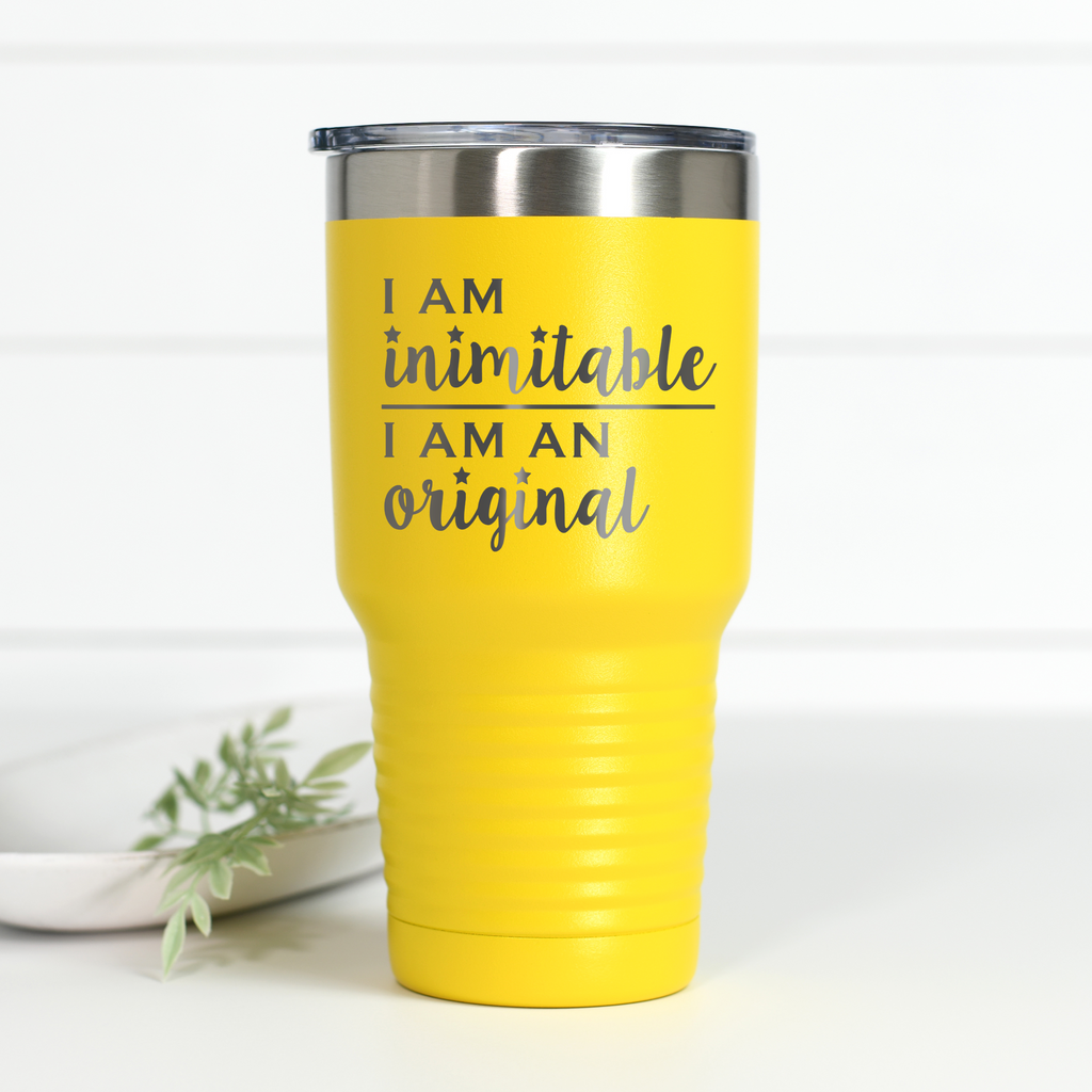 Bright yellow 30 oz stainless steel tumbler with the text I Am Inimitable I Am An Original engraved on the front