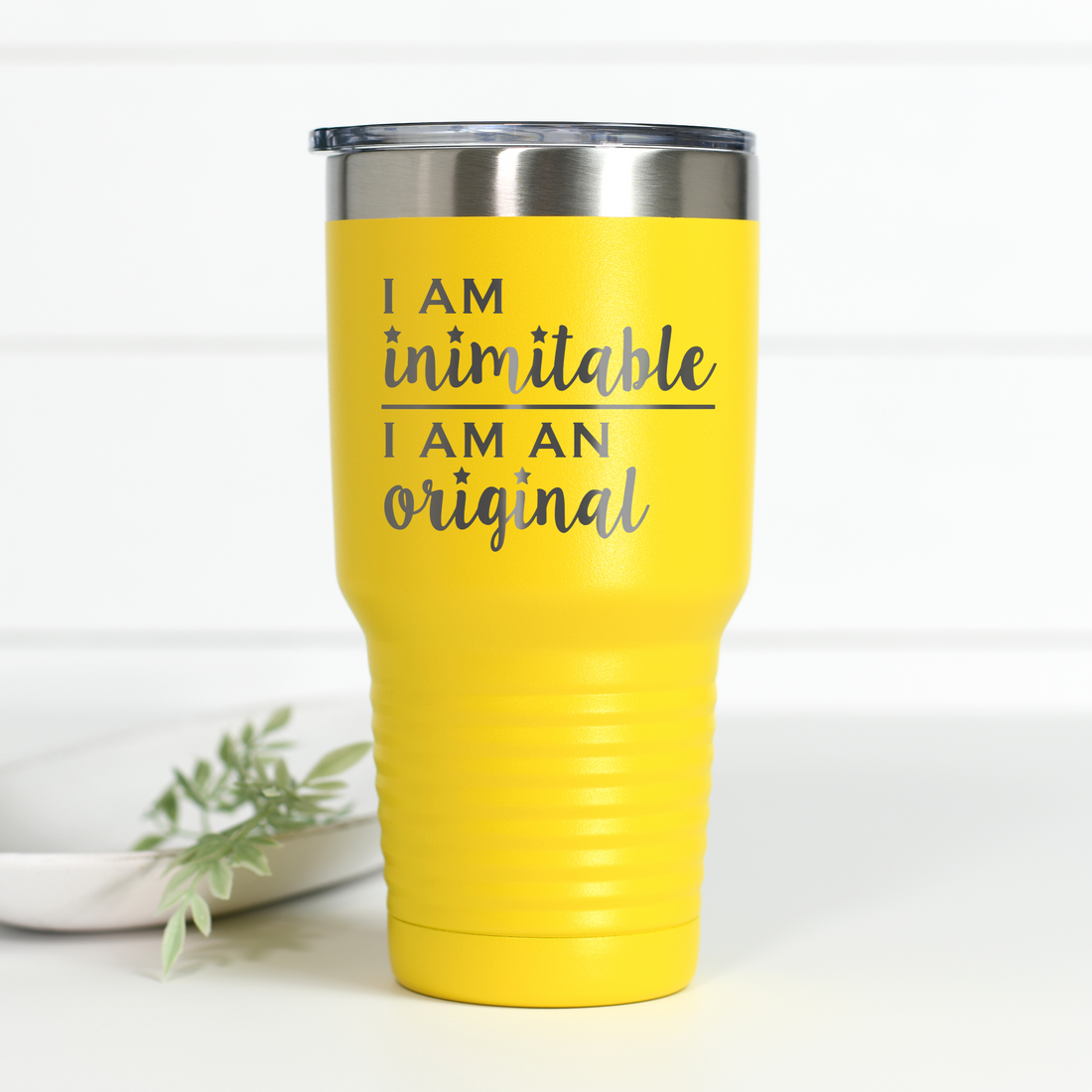 Bright yellow 30 oz stainless steel tumbler with the text I Am Inimitable I Am An Original engraved on the front