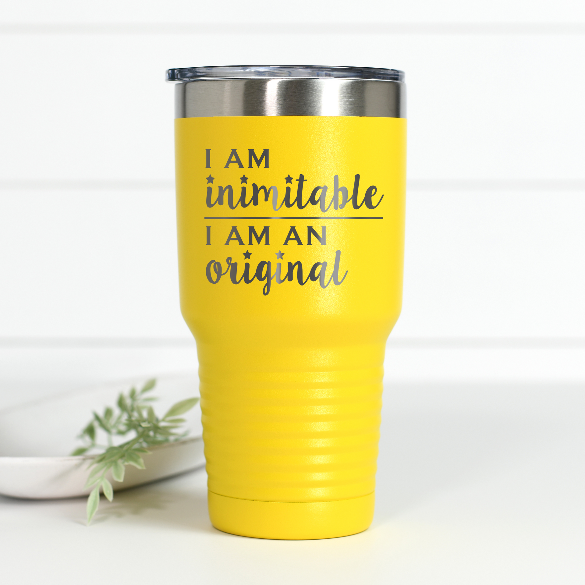 Bright yellow 30 oz stainless steel tumbler with the text I Am Inimitable I Am An Original engraved on the front