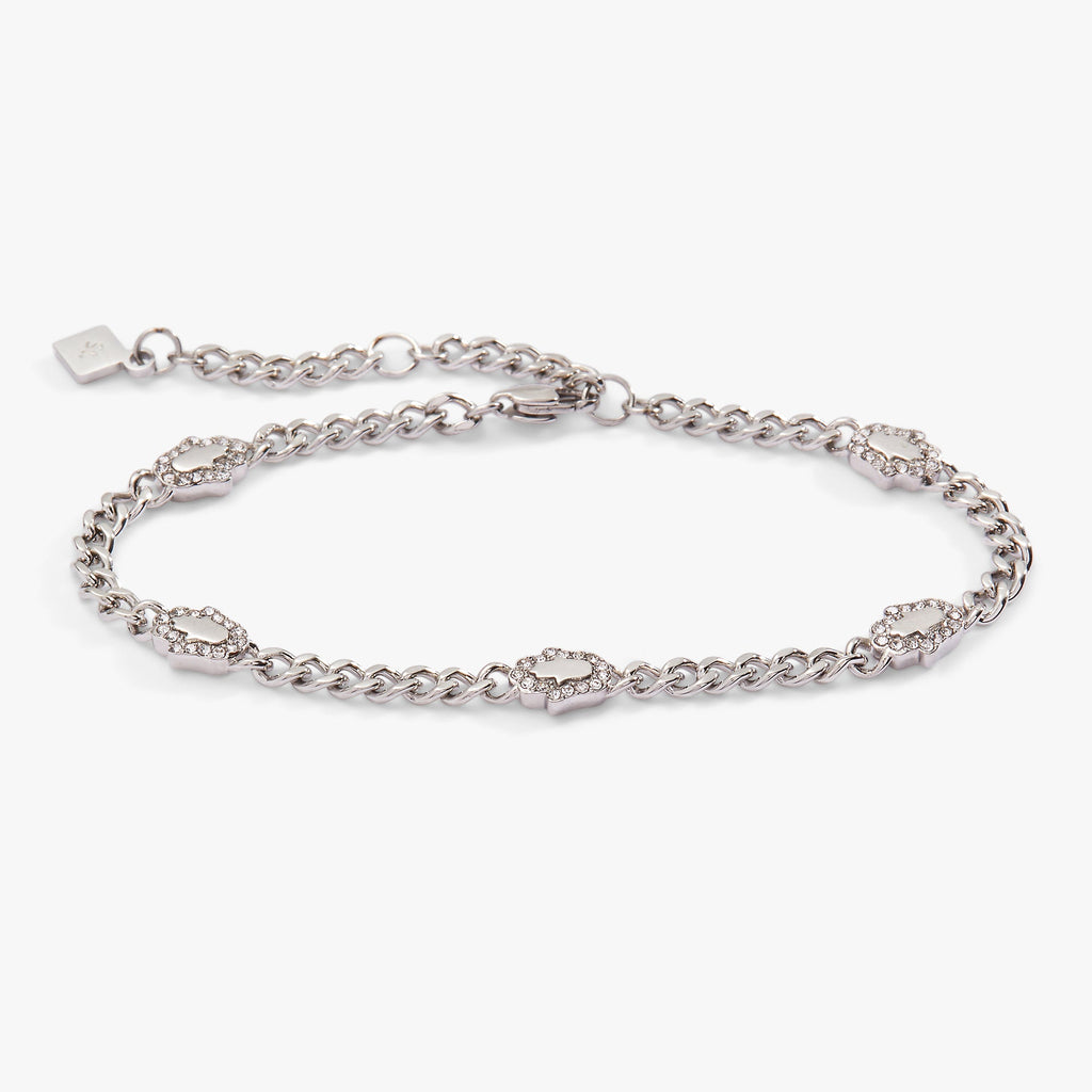 A silver curb chain bracelet featuring five crystal-accented Hamsa hand charms.