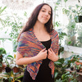 Close up of a hand beaded silk shawl in vibrant orange, blue, purple, and teal colors