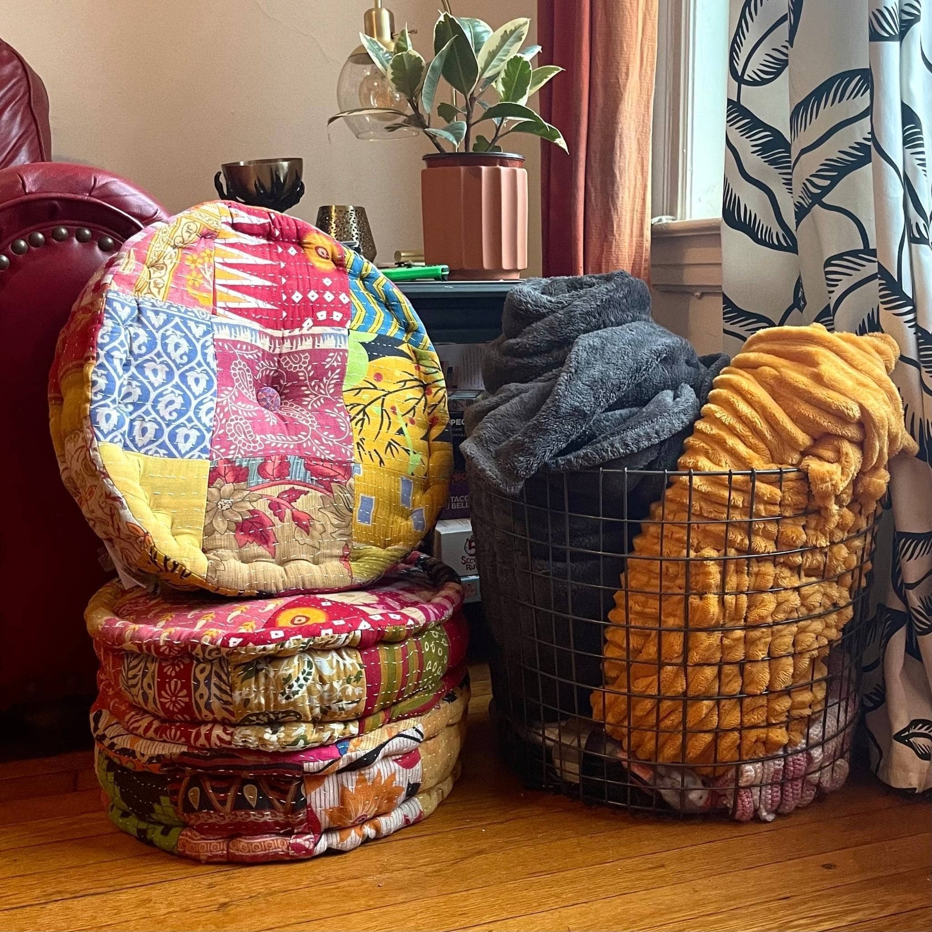 Vibrant hand embroidered boho cotton floor pouf in a living room setting