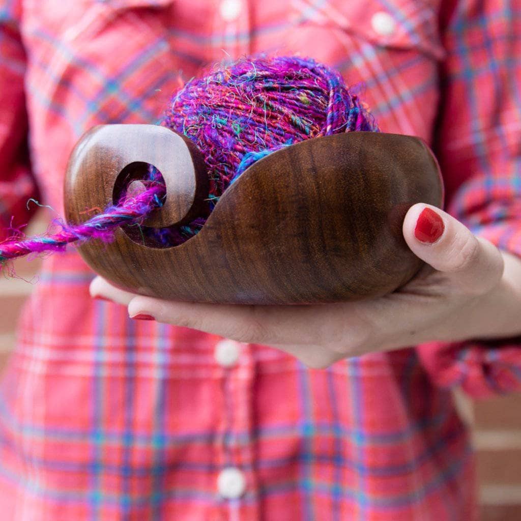Handmade round Sheesham wood yarn bowl with a smooth finish, ideal for knitting and crochet organization.