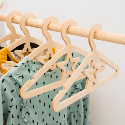 A set of 10 small wooden hangers designed for toddler and baby clothing.