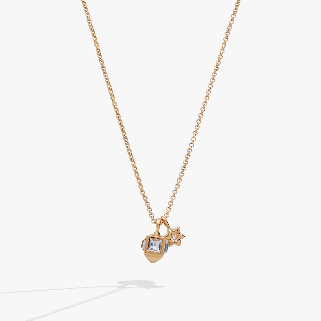 Gold-tone necklace featuring a 3D dreidel charm with aquamarine crystals and a crystal-accented Star of David.