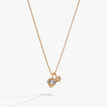 Gold-tone necklace featuring a 3D dreidel charm with aquamarine crystals and a crystal-accented Star of David.