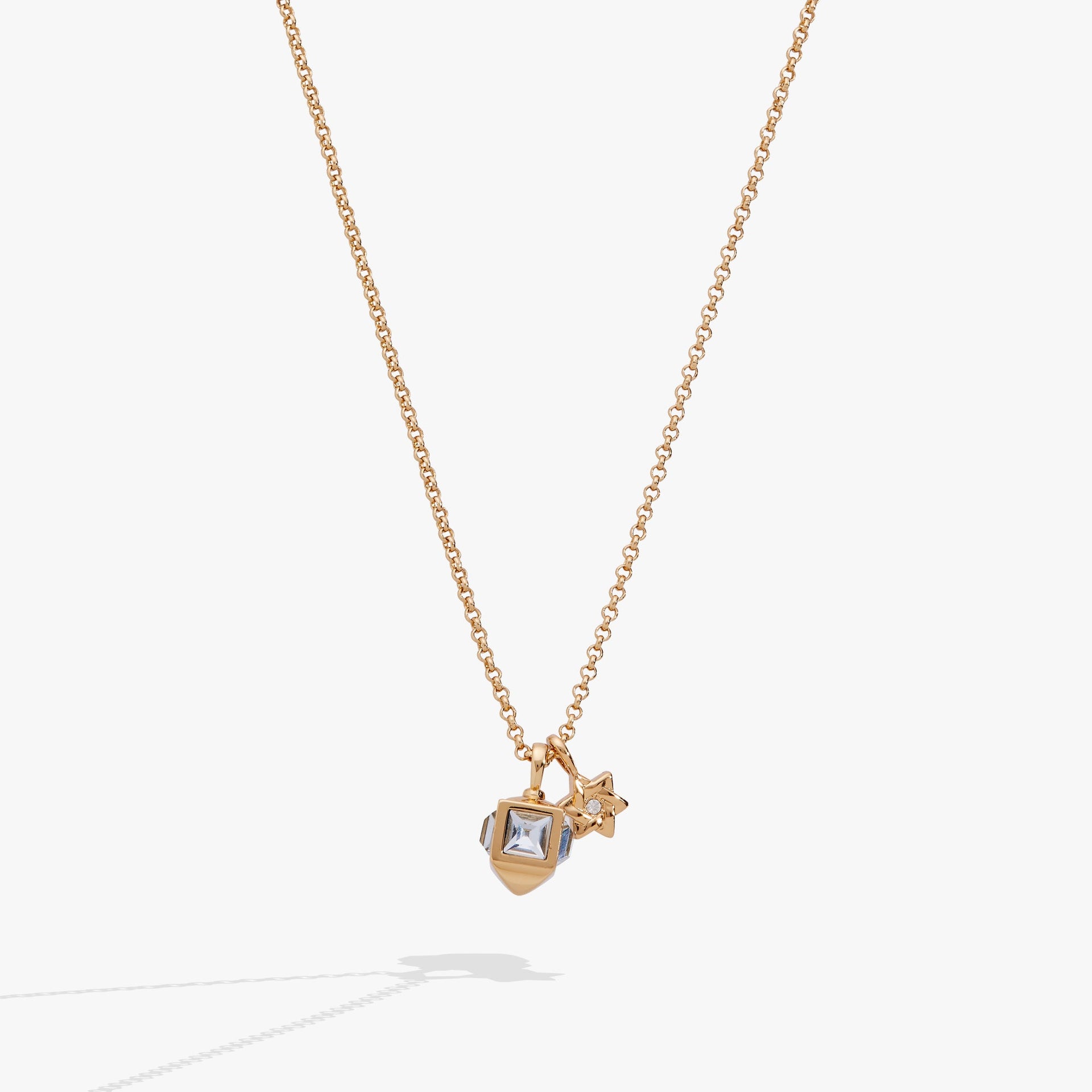 Gold-tone necklace featuring a 3D dreidel charm with aquamarine crystals and a crystal-accented Star of David.