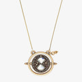 Polished gold Harry Potter Time Turner spinner necklace with iridescent crystal accents on a cable chain.