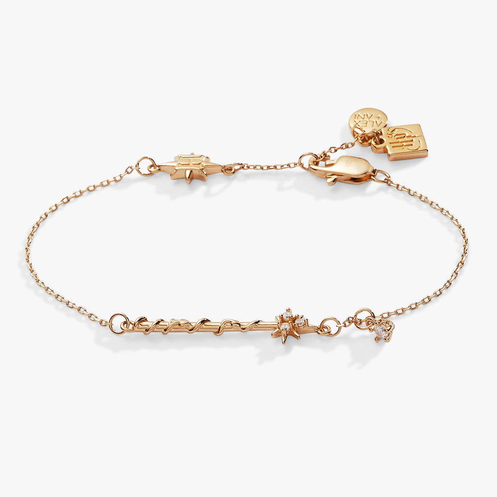 Gold-tone Harry Potter Hermione wand charm bracelet featuring a star-shaped crystal accent and adjustable chain.