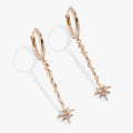 Close-up of Harry Potter Hermione Granger wand hoop earrings with crystal magic bursts.