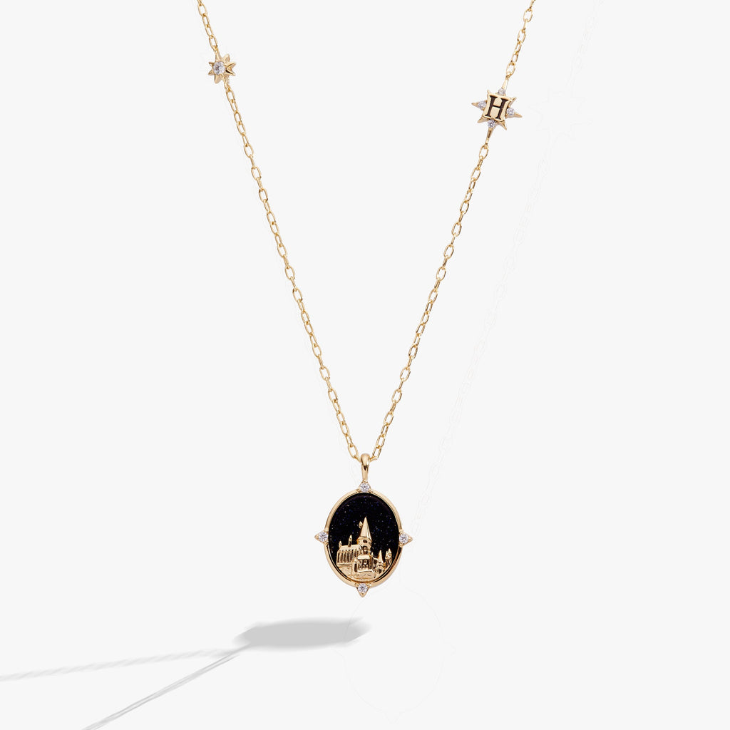 Gold-plated Hogwarts castle pendant necklace featuring a blue sunstone background and crystal accents.