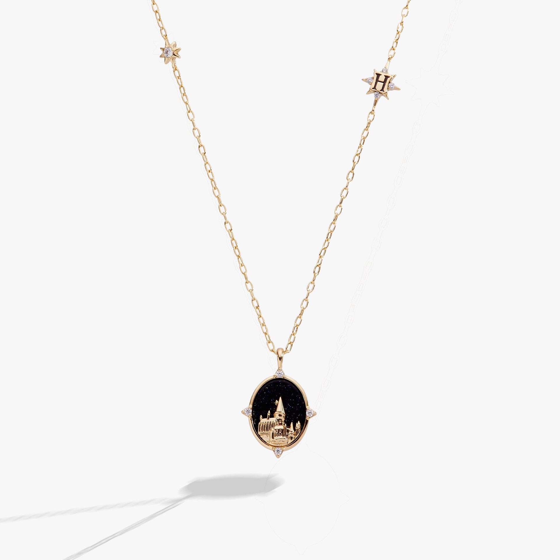 Gold-plated Hogwarts castle pendant necklace featuring a blue sunstone background and crystal accents.
