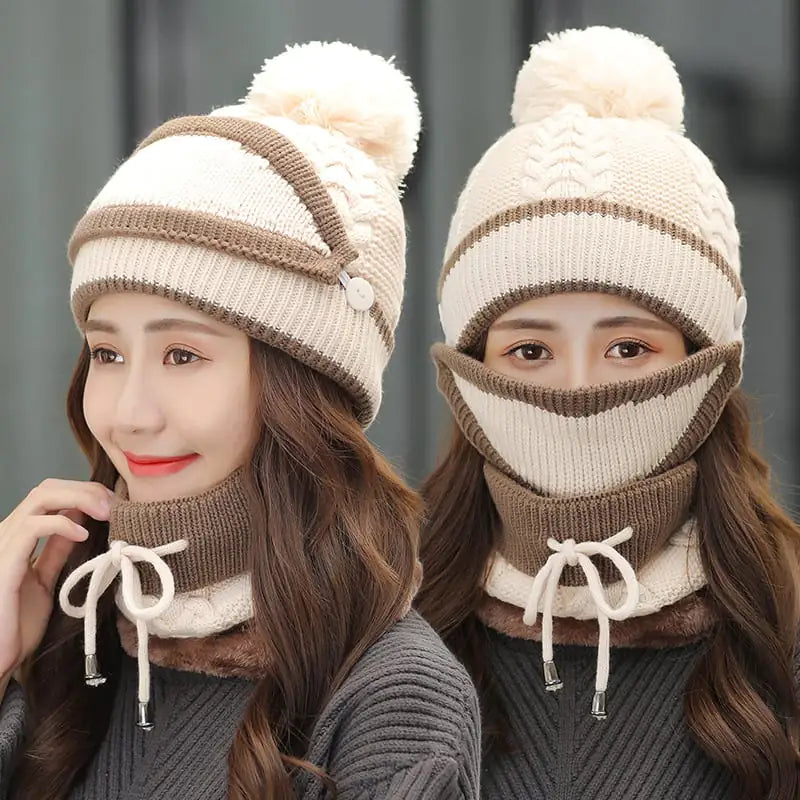 A woman wearing a three-piece winter set including a pom-pom beanie, a scarf, and a detachable face mask.