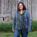 Headlands Crochet Scarf pattern shown in vibrant jewel-toned lime green, magenta, and blue yarn