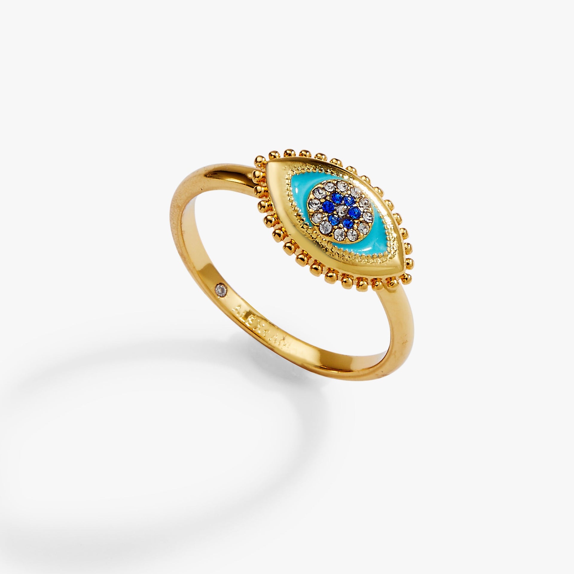 Close-up view of a delicate Evil Eye ring with enamel detailing and sapphire accents on a finger