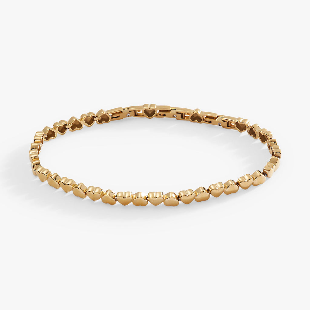 Silver-tone stainless steel tennis bracelet featuring heart charms in a delicate, adjustable design.