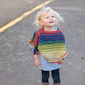Vibrant rainbow striped crochet toddler poncho made from herbal dyed silk yarn