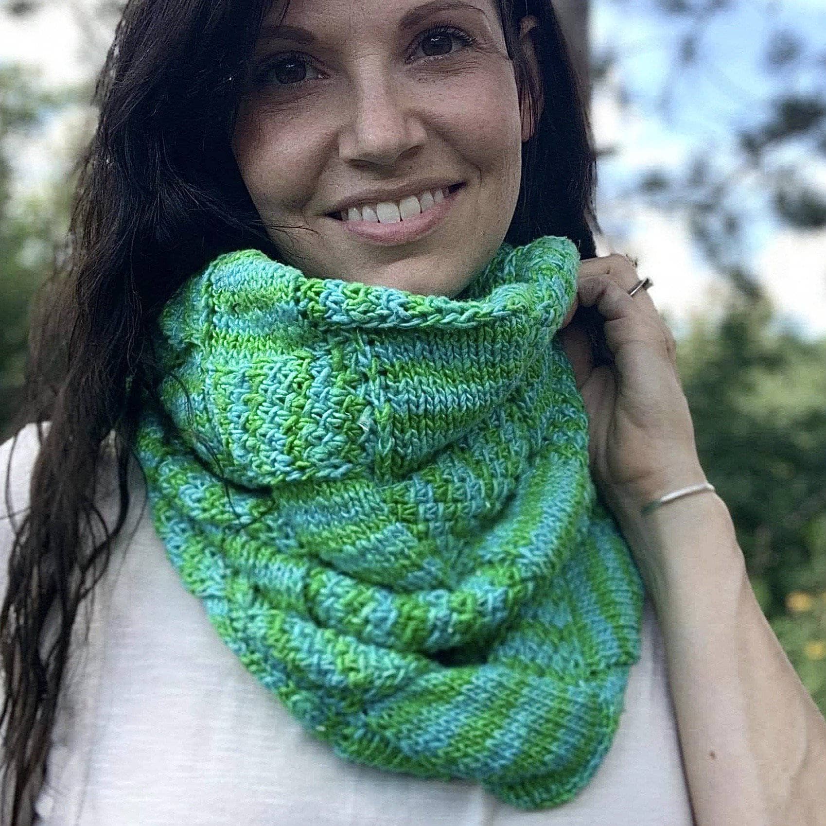 Handmade entrelac style cowl in vibrant green, blue, yellow, and pink silk roving yarn