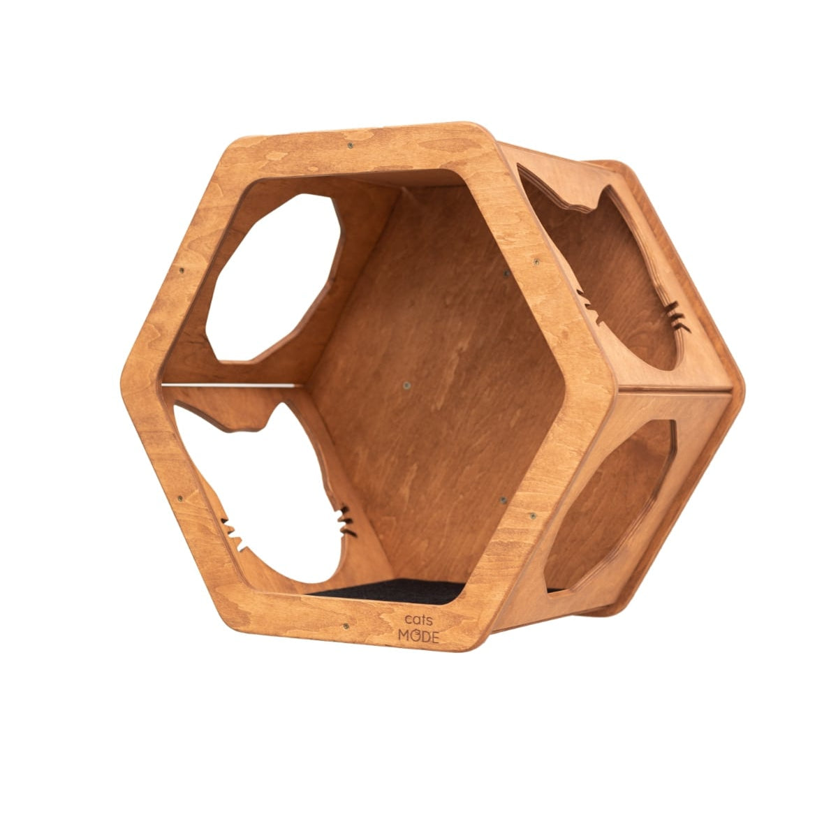 Modern hexagon-shaped oak wood cat wall shelf with black felt interior lining mounted on a living room wall.
