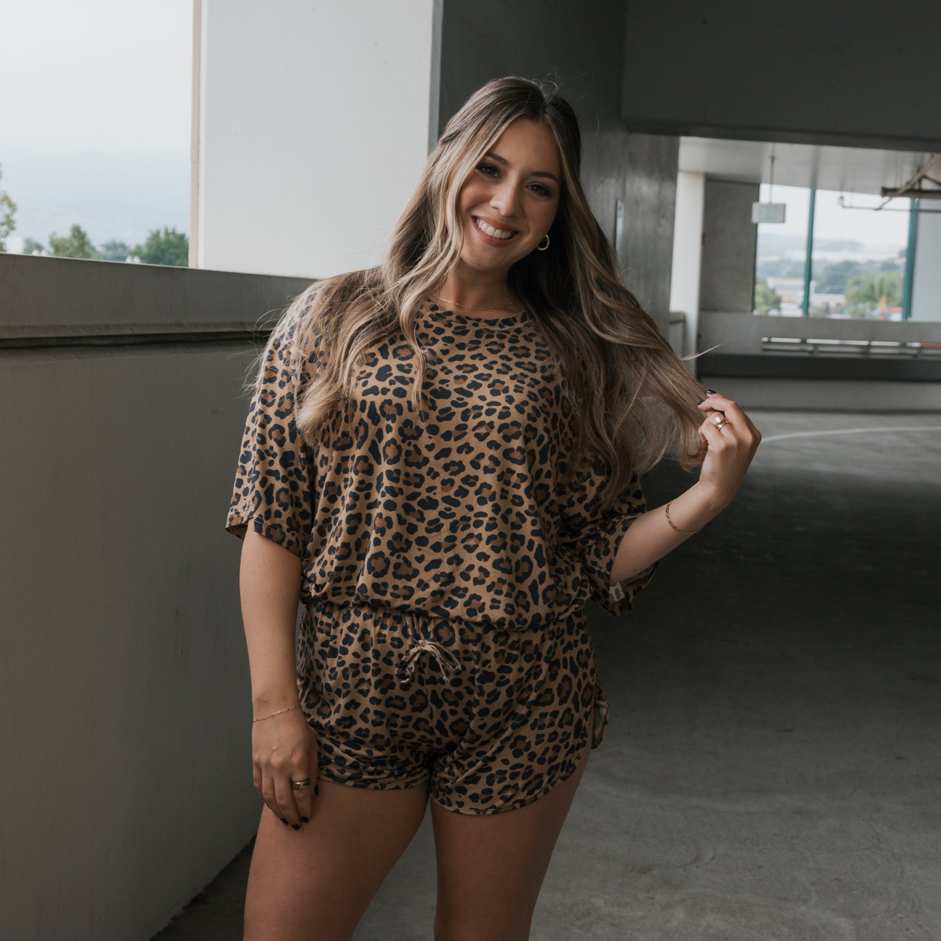 Woman wearing a relaxed-fit leopard print bamboo short set in a casual indoor setting