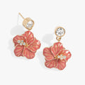 A pair of Hibiscus Drop Earrings featuring crystal-embellished flower charms and a diamond-dupe base.