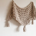 A close-up of a chunky, textured hand-knitted shawl made using the Hickory Tree Arm Knit Pattern.